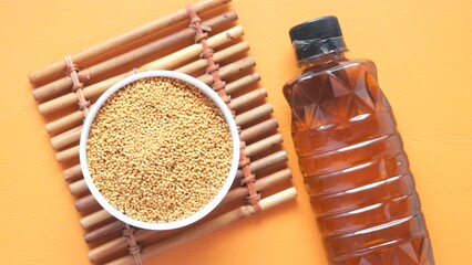 Wall Mural - Mustard oil in a plastic jar and seeds in a container 