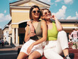 © halayalex - Two young beautiful smiling hipster female in trendy summer t-shirt and shorts clothes. Sexy carefree women posing on street background. Positive models having fun, hugging. In sunglasses
