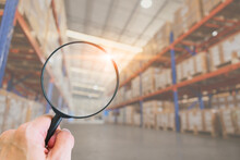 Magnify Glass On Warehouse Inventory Background. Searching Products Stock Finding Cargo Lot Number Shelf Management Concept.