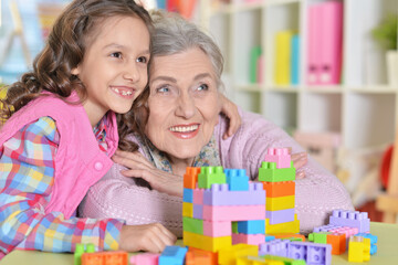 Poster - Cute girl and grandmother playing