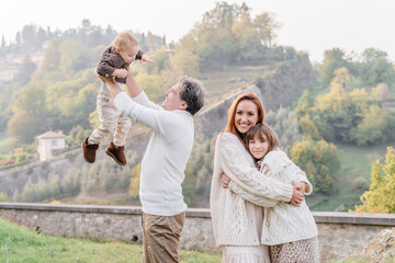 Wall Mural - A stylish family with two children in a view point of Bergamo, Italy