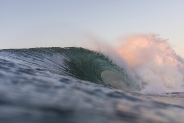 huge dangerous wave breaking on a shallow reef in the ocean