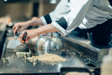 Wall Mural - Hand of man take cooking of meat with vegetable grill, Chef cooking wagyu beef in Japanese teppanyaki restaurant