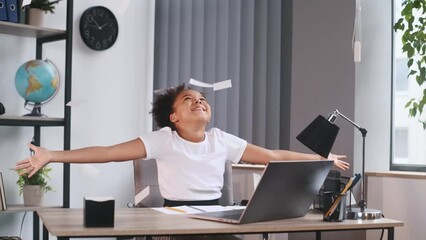 Wall Mural - Throwing stickers up in the air. Celebrating success. Cute female african american student child is sitting by the laptop.