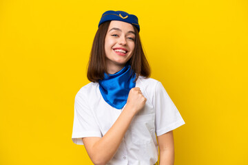 Wall Mural - Airplane stewardess Ukrainian woman isolated on yellow background celebrating a victory