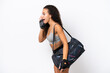 © luismolinero - Young sport Arab woman with sport bag isolated on white background shouting with mouth wide open to the lateral