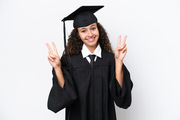 Wall Mural - Young university graduate Arab woman isolated on white background showing victory sign with both hands