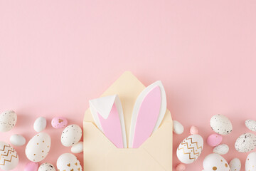 Wall Mural - Easter concept. Top view photo of open beige envelope with easter bunny ears pink white eggs on isolated pastel pink background with copyspace
