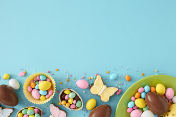 Wall Mural - Easter sweets concept. Top view photo of green plate with chocolate easter eggs with dragees gingerbread and sprinkles on isolated pastel blue background with empty space
