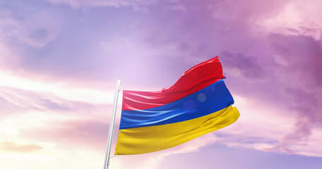 Waving Flag of Armenia in Blue Sky. The symbol of the state on wavy cotton fabric.