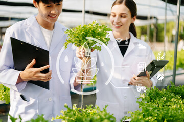 biologist puts sprout in test tube for laboratory analyze. two scientists stand in organic farm. che