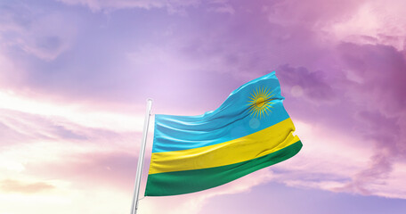 Waving Flag of Rwanda in Blue Sky. The symbol of the state on wavy cotton fabric.