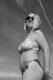 Fototapeta  - Portret kobiety w bikini na tle nieba