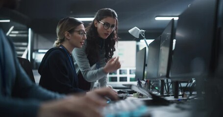 Cinematic Footage of a Two Beautiful Women Working in a Cyber Security Software Development Department. Young Manager Updating Software Developer on the Artificial Intelligence Safety Project