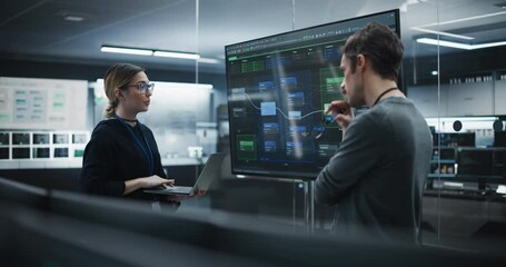 Fototapete - Two Diverse Software Developers Having a Meeting in a Conference Room. Female and Male Tech Industry Engineers Brainstorming Ideas for Their Neural Network Blockchain Startup