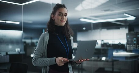 Portrait of a Happy Smiling Female, Using Laptop Computer, Looking at Camera and Smiling. Empowered Information Technology Specialist, Software Engineer or Developer