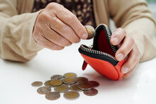 Retired Elderly Woman Counting Coins Money And Worry About Monthly Expenses And Treatment Fee Payment.