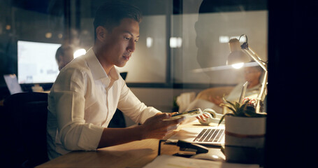 Wall Mural - Asian businessman, laptop and phone at night working in marketing or advertising at office. Japanese employee man in web design at work on computer checking email, networking or online at workplace