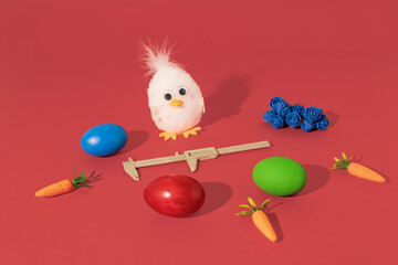  Easter Chicken, eggs, carrots, caliper and blue roses on red background. Minimal horizontal composition, funny Easter decoration concept