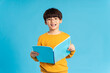 © Q88 - Portrait of Asian school boy born on a blue background
