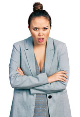 Canvas Print - Young hispanic girl wearing business clothes in shock face, looking skeptical and sarcastic, surprised with open mouth