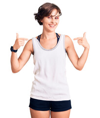 Beautiful young woman with short hair wearing casual sport clothes looking confident with smile on face, pointing oneself with fingers proud and happy.