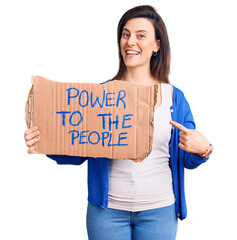 Wall Mural - Young beautiful woman holding power to the people banner smiling happy pointing with hand and finger