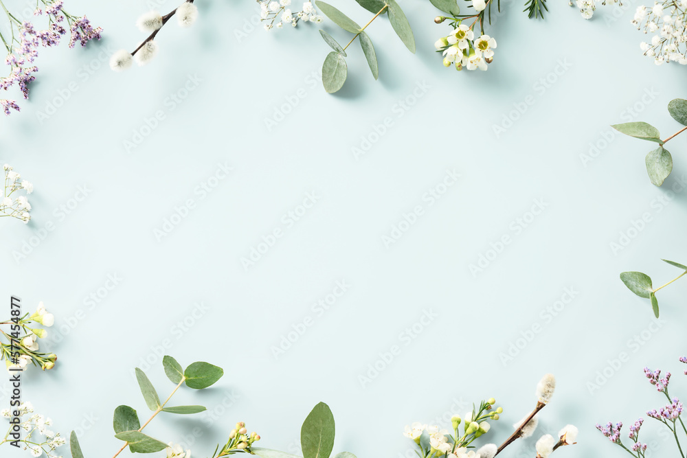 Spring flower frame on blue background copy space flat lay mock up ...