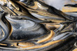 © ADDICTIVE STOCK - Golden and silver pigment in black dye