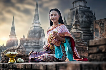 buddha in temple. Beauty fantasy Thai women. Beautiful Thai girl in traditional dress costume , Ayutthaya province, Thailand. Asian women wearing traditional Thai culture, vintage style, Thai