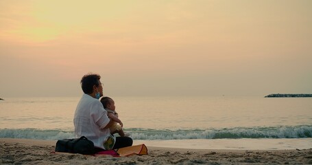 Wall Mural - happiness Asian family grandmother is keeping holding cute adorable newborn baby infant girl on her arms relaxing at seaside tropical beach sunrise sunset during holiday vacation in Thailand
