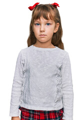 Wall Mural - Little caucasian girl kid wearing casual clothes relaxed with serious expression on face. simple and natural looking at the camera.