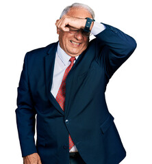 Sticker - Senior man with grey hair wearing business suit and glasses covering eyes with arm smiling cheerful and funny. blind concept.