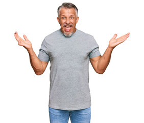 Poster - Middle age grey-haired man wearing casual clothes celebrating victory with happy smile and winner expression with raised hands