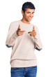 © Krakenimages.com - Young african amercian man wearing casual clothes pointing fingers to camera with happy and funny face. good energy and vibes.