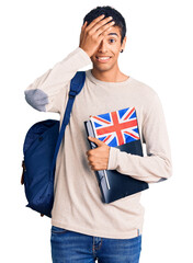 Canvas Print - Young african amercian man wearing student backpack holding binder and uk flag stressed and frustrated with hand on head, surprised and angry face