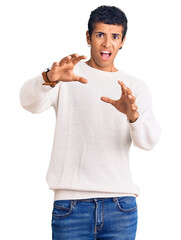 Poster - Young african amercian man wearing casual clothes afraid and terrified with fear expression stop gesture with hands, shouting in shock. panic concept.