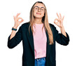 © Krakenimages.com - Hispanic young woman wearing business jacket and glasses relaxed and smiling with eyes closed doing meditation gesture with fingers. yoga concept.