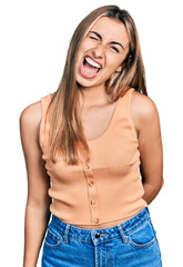 Canvas Print - Hispanic young woman wearing casual summer shirt winking looking at the camera with sexy expression, cheerful and happy face.