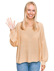 Sticker - Young blonde girl wearing casual clothes showing and pointing up with fingers number five while smiling confident and happy.