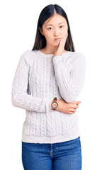 Poster - Young beautiful chinese woman wearing casual sweater thinking looking tired and bored with depression problems with crossed arms.