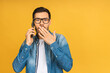 Young handsome man talking on smartphone isolated against yellow background scared in shock with a surprise face, afraid and excited with fear expression.