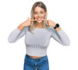 © Krakenimages.com - Beautiful blonde woman wearing casual clothes smiling cheerful showing and pointing with fingers teeth and mouth. dental health concept.