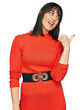 © Krakenimages.com - Young hispanic woman wearing casual clothes smiling with happy face looking and pointing to the side with thumb up.