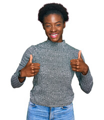 Sticker - Young african american girl wearing casual clothes success sign doing positive gesture with hand, thumbs up smiling and happy. cheerful expression and winner gesture.