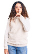 © Krakenimages.com - Beautiful kid girl with curly hair wearing casual clothes asking to be quiet with finger on lips. silence and secret concept.