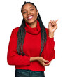 © Krakenimages.com - African american woman wearing casual winter sweater with a big smile on face, pointing with hand and finger to the side looking at the camera.