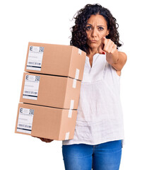 Wall Mural - Middle age beautiful woman holding delivery package pointing with finger to the camera and to you, confident gesture looking serious