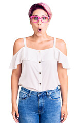 Sticker - Young beautiful woman with pink hair wearing casual clothes and glasses afraid and shocked with surprise expression, fear and excited face.