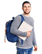 © Krakenimages.com - Young handsome man wearing student backpack holding notebook looking positive and happy standing and smiling with a confident smile showing teeth